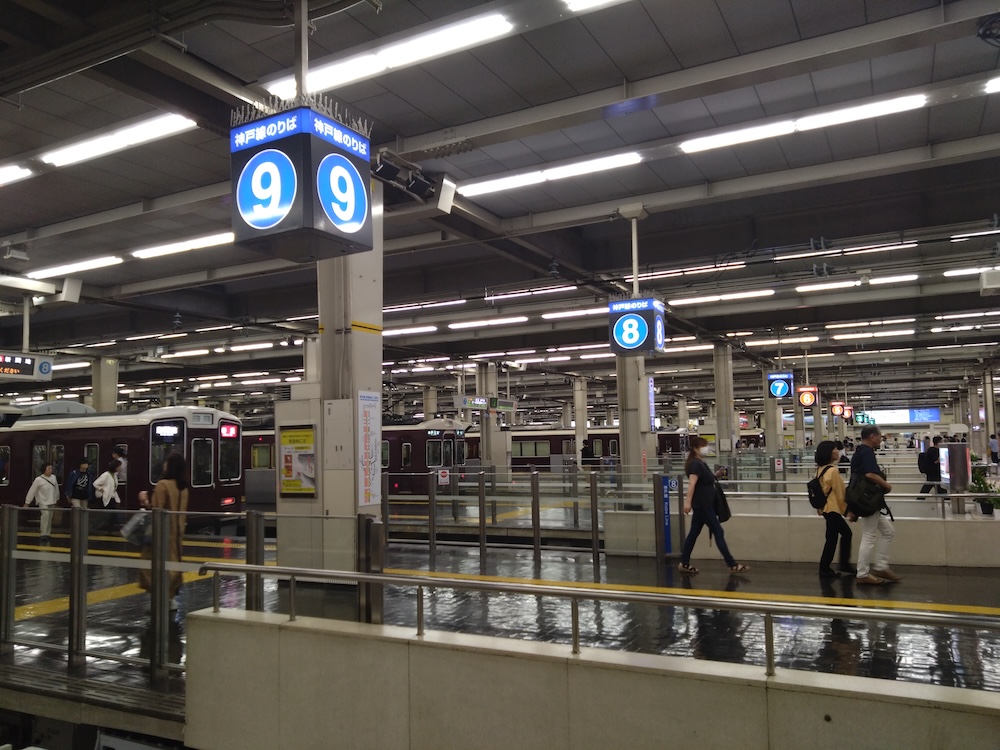 Busy Hankyu Umeda Station with its distinctive fan-shaped platform layout
